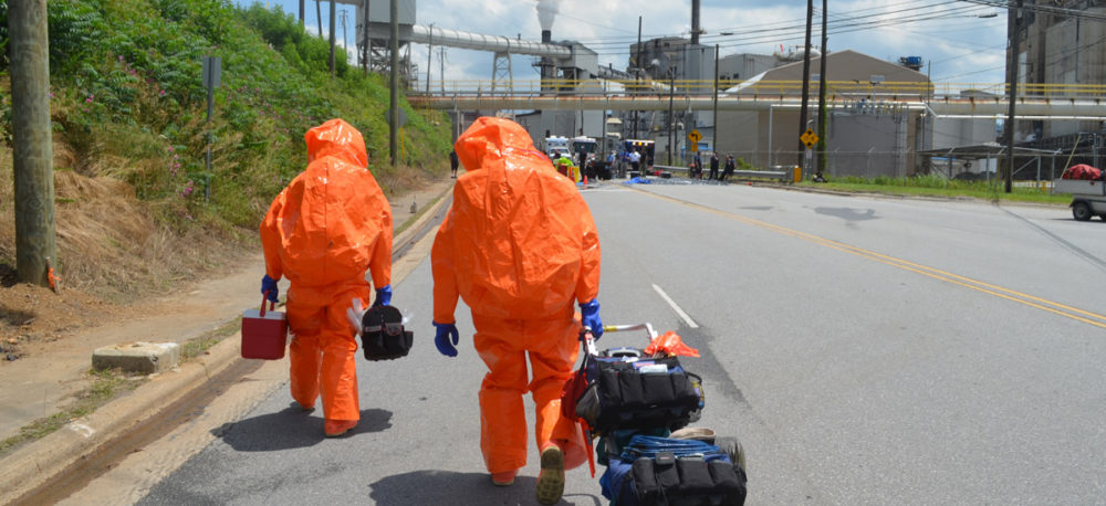 Emergency workers entering a chemical plant.